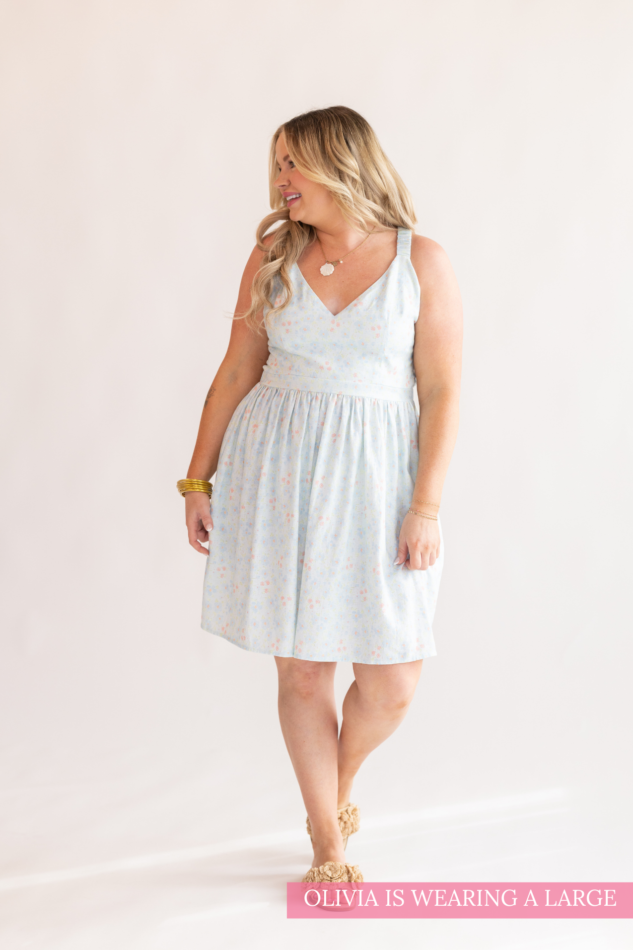 Woman wearing a light blue dress on a white background